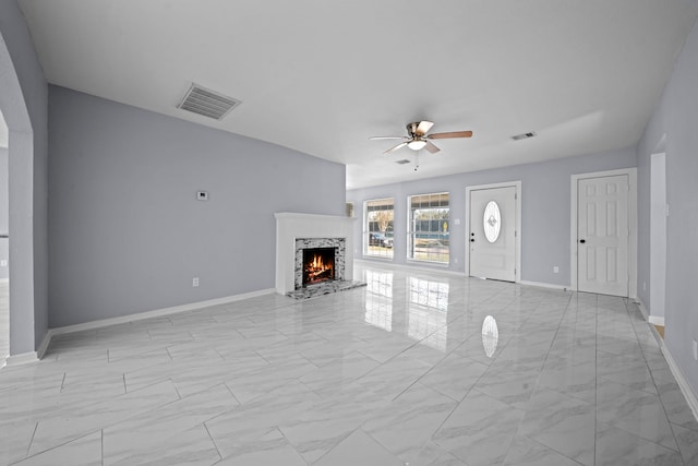 unfurnished living room with ceiling fan