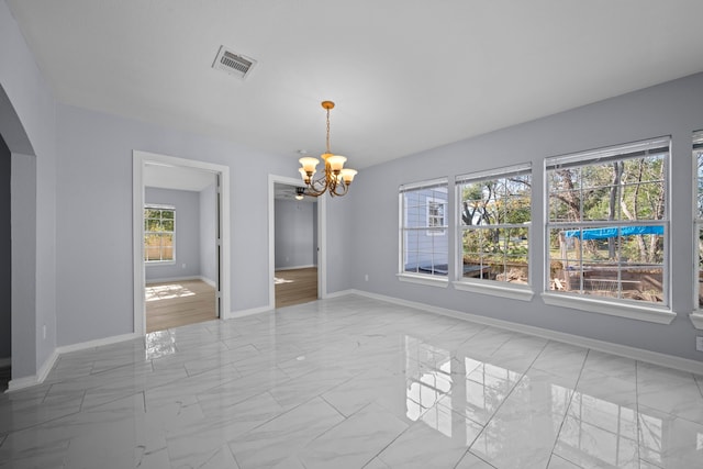 unfurnished dining area with a notable chandelier