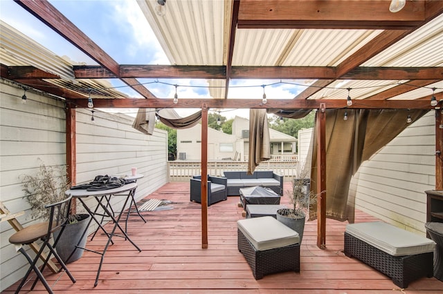 wooden deck with an outdoor living space