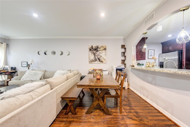 living room with dark wood-type flooring and crown molding