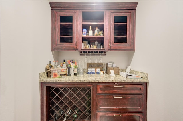 bar featuring light stone countertops