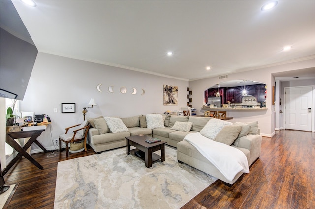 living room featuring hardwood / wood-style flooring and ornamental molding