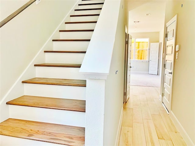 stairs with wood-type flooring