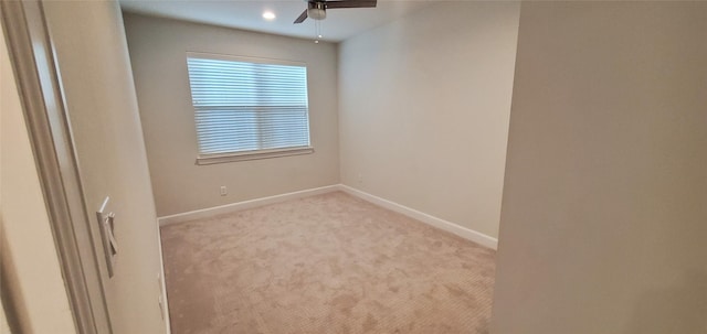 unfurnished room with ceiling fan and light colored carpet