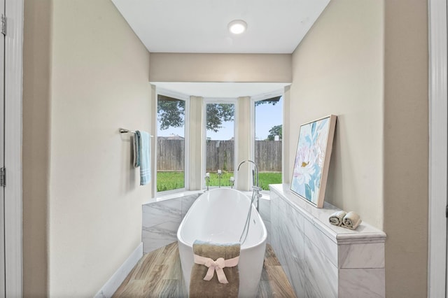 sitting room with tile walls and light wood-type flooring