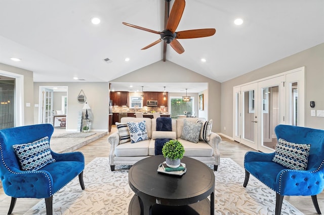 living room featuring ceiling fan, lofted ceiling with beams, french doors, and light wood-type flooring