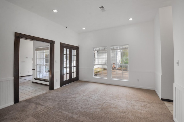 carpeted empty room featuring french doors