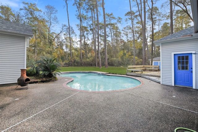 view of swimming pool with a lawn and a patio