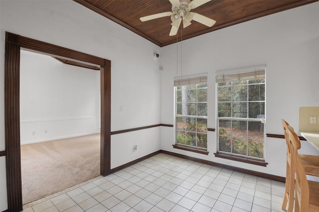 carpeted empty room featuring ceiling fan, wooden ceiling, and ornamental molding