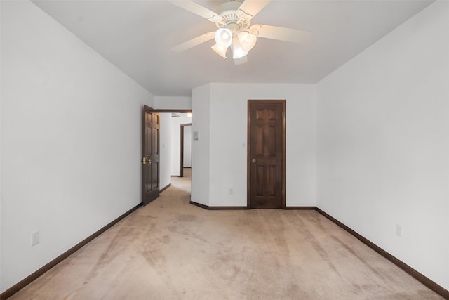 unfurnished bedroom with ceiling fan and light colored carpet