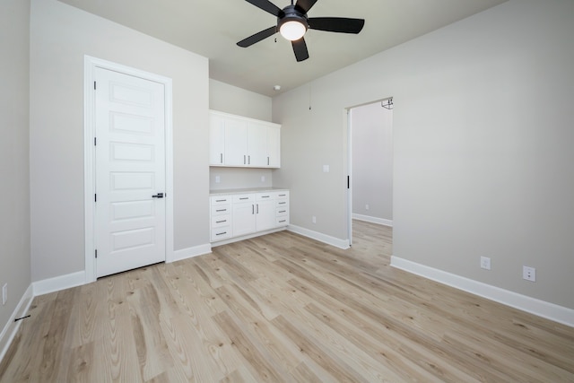 unfurnished bedroom with ceiling fan and light wood-type flooring