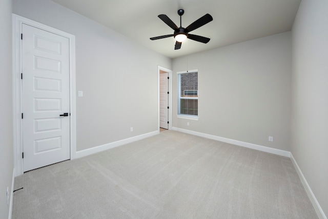 empty room with light carpet and ceiling fan