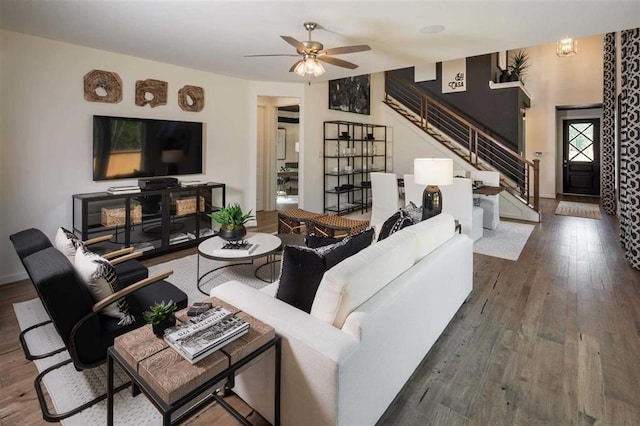 living room with ceiling fan and dark wood-type flooring