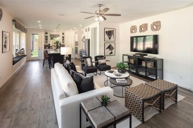 living room with sink, ceiling fan, and dark hardwood / wood-style floors