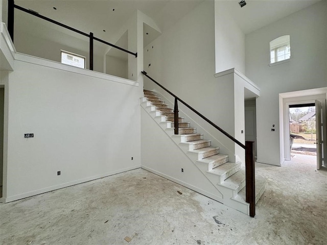 stairs featuring a towering ceiling