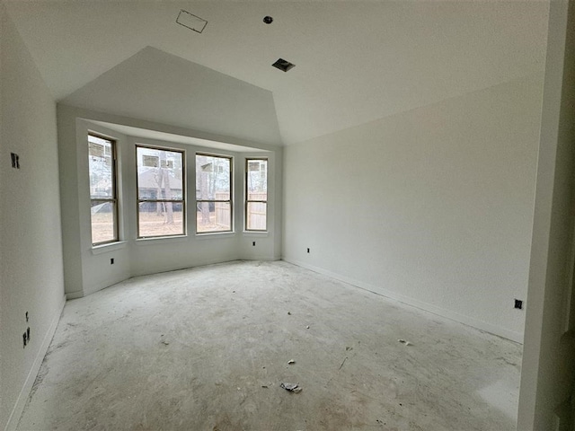 empty room featuring vaulted ceiling