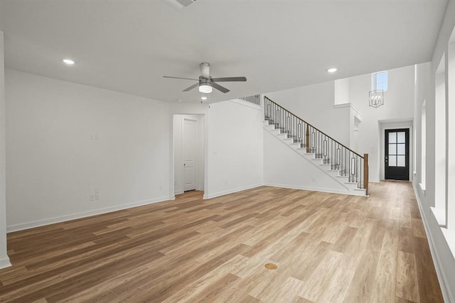 7462 Cattail Falls Ln, Porter, TX 77365 - unfurnished living room featuring stairway, light wood-style floors, ceiling fan, baseboards, and recessed lighting