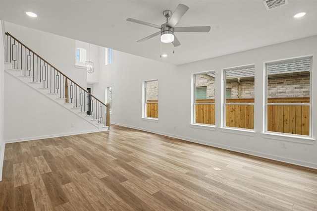 7462 Cattail Falls Ln, Porter, TX 77365 - unfurnished living room featuring stairs, light wood-type flooring, ceiling fan, baseboards, and recessed lighting