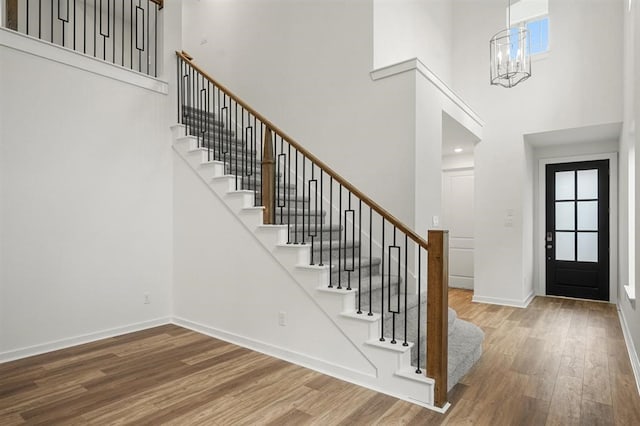 7462 Cattail Falls Ln, Porter, TX 77365 - entryway featuring a towering ceiling, wood finished floors, stairs, baseboards, and a chandelier