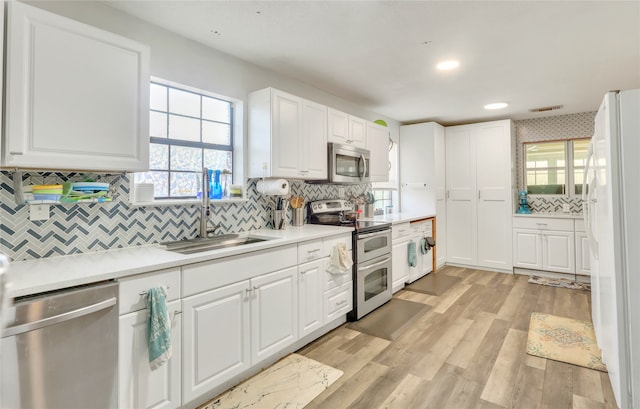 kitchen featuring white cabinetry, sink, and appliances with stainless steel finishes