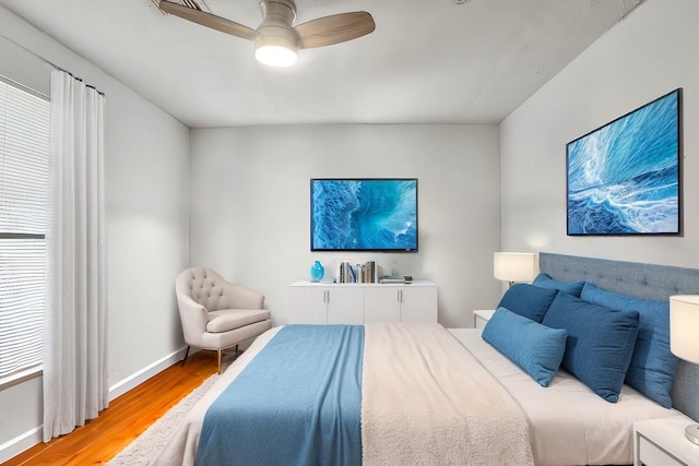 bedroom with ceiling fan and wood-type flooring