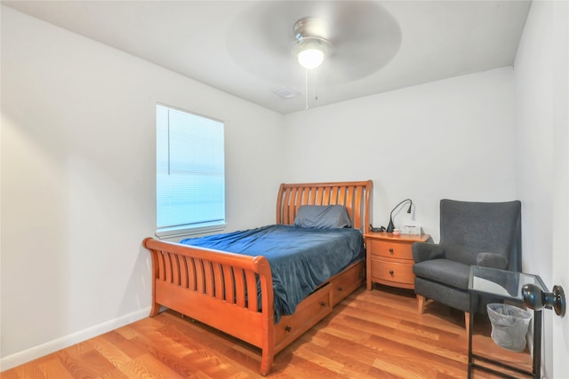 bedroom with light hardwood / wood-style floors and ceiling fan