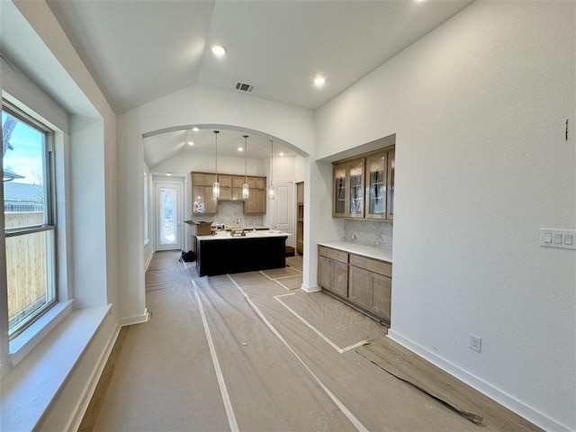 bathroom featuring tasteful backsplash and vaulted ceiling