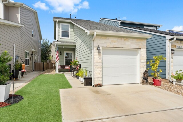 view of front of property with a garage and a front yard