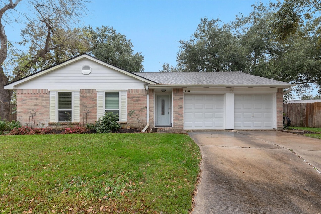 ranch-style house with a front lawn and a garage