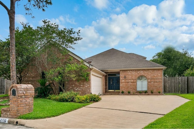 view of front facade with a garage and a front yard