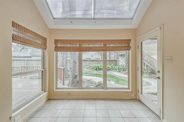 unfurnished sunroom featuring vaulted ceiling and a wealth of natural light