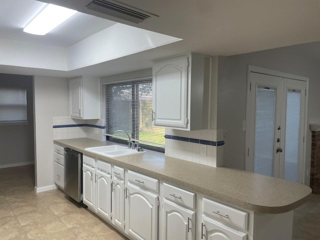 kitchen featuring white cabinets, decorative backsplash, dishwasher, and sink