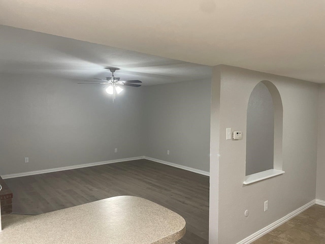 unfurnished room with ceiling fan and dark hardwood / wood-style floors