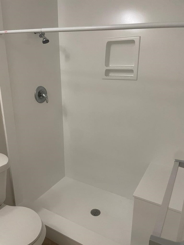 bathroom with toilet and walk in shower