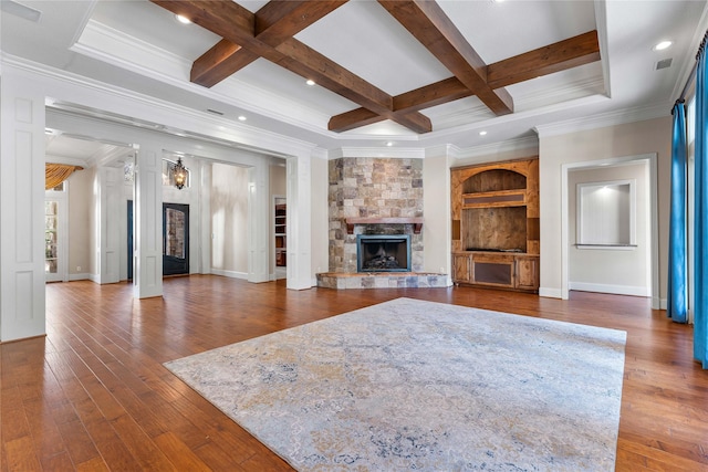 unfurnished living room with beamed ceiling, a fireplace, hardwood / wood-style flooring, crown molding, and coffered ceiling