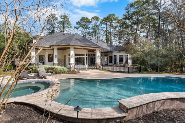 view of pool featuring an in ground hot tub and a patio