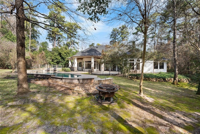 view of yard featuring an outdoor fire pit and a patio area