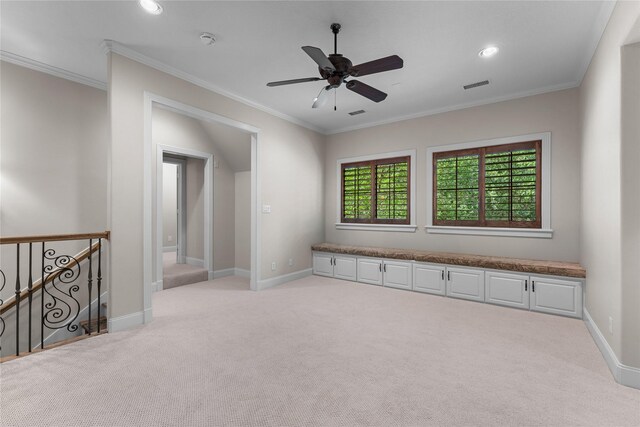 carpeted empty room featuring ceiling fan and ornamental molding