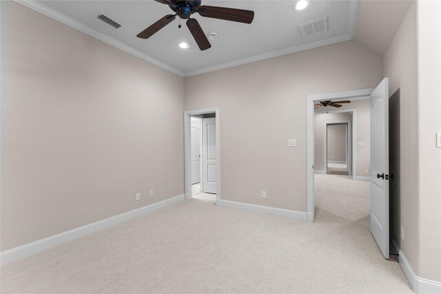 unfurnished bedroom with light carpet, ceiling fan, ornamental molding, and lofted ceiling