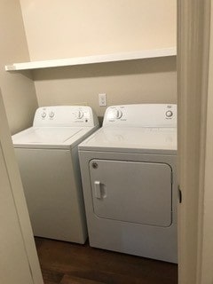 laundry area featuring dark hardwood / wood-style flooring and washing machine and clothes dryer