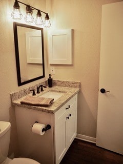 bathroom featuring toilet and vanity