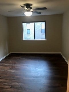 unfurnished room with ceiling fan and dark hardwood / wood-style floors