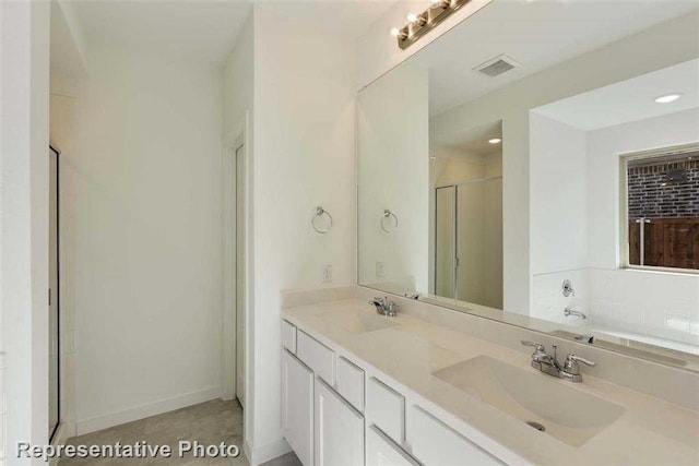 bathroom with vanity, tile patterned flooring, and plus walk in shower