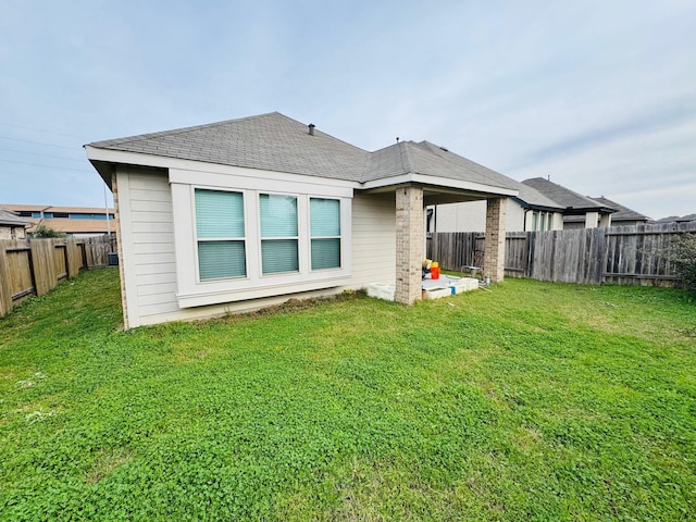 rear view of house with a yard