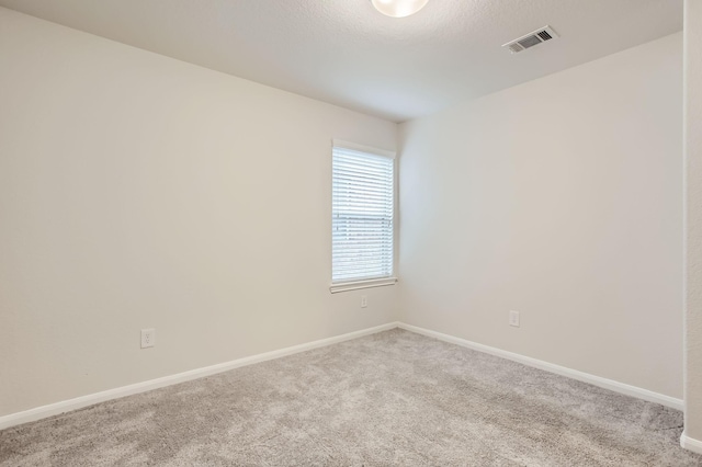 unfurnished room with light carpet