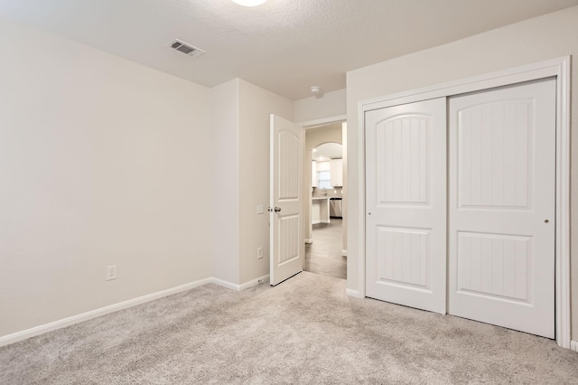 7535 Cypress Pin Oak Dr, Cypress, TX 77433 - unfurnished bedroom with carpet flooring, baseboards, a textured ceiling, visible vents, and a closet