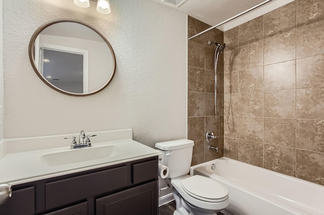 full bathroom featuring toilet, tiled shower / bath combo, and vanity