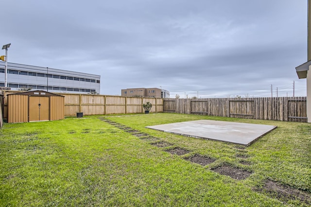 view of yard with a storage shed and a patio