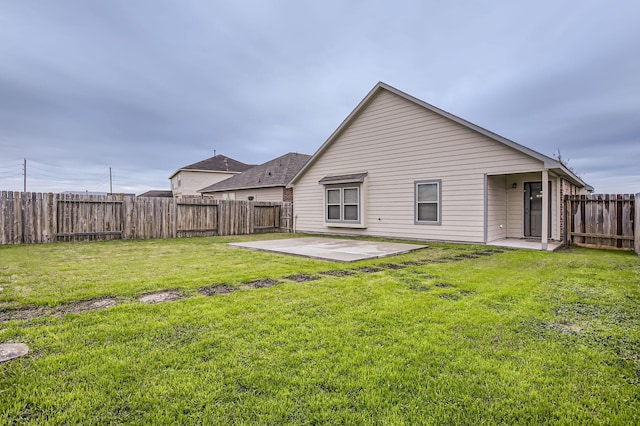 back of property featuring a patio area and a yard