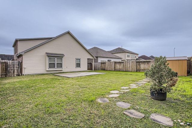 back of house with a patio area and a lawn